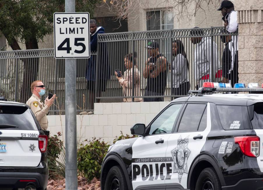 Milan apartment townhomes residents listen to a Metropolitan police officerÕs instructions ...