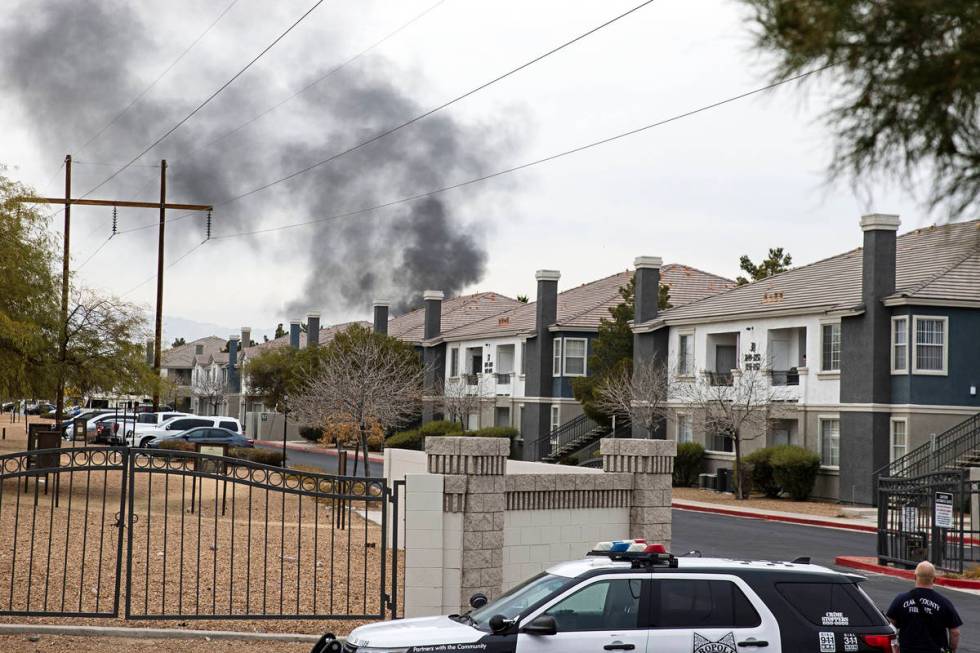 Black smoke is seen from an apartment building where the Metropolitan Police Department is inve ...