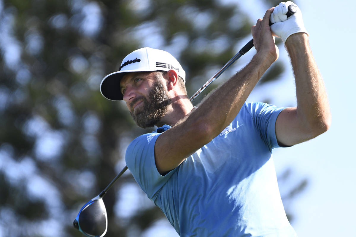 Dustin Johnson watches a shot during the second round of the Tournament of Champions golf event ...