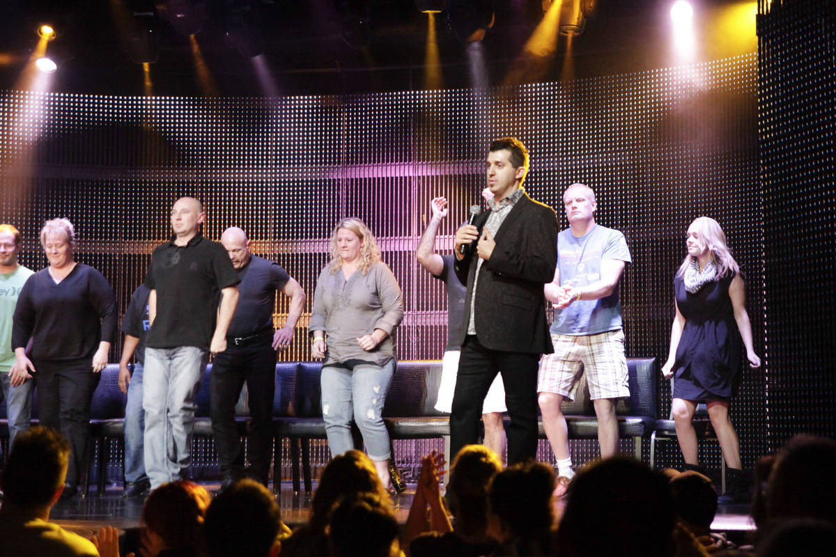 In this Nov. 21, 2013, file photo, comic hypnotist Marc Savard, center, mocks volunteer guests ...