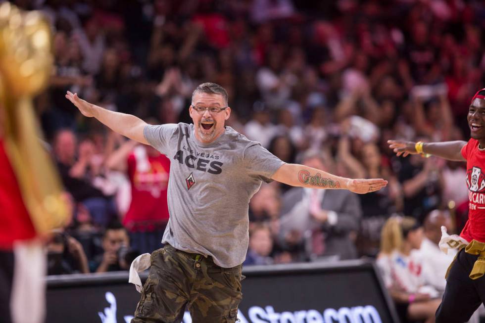 Russ Canty celebrates after winning a "pop-a-shot" contest during Vegas' WNBA semifin ...