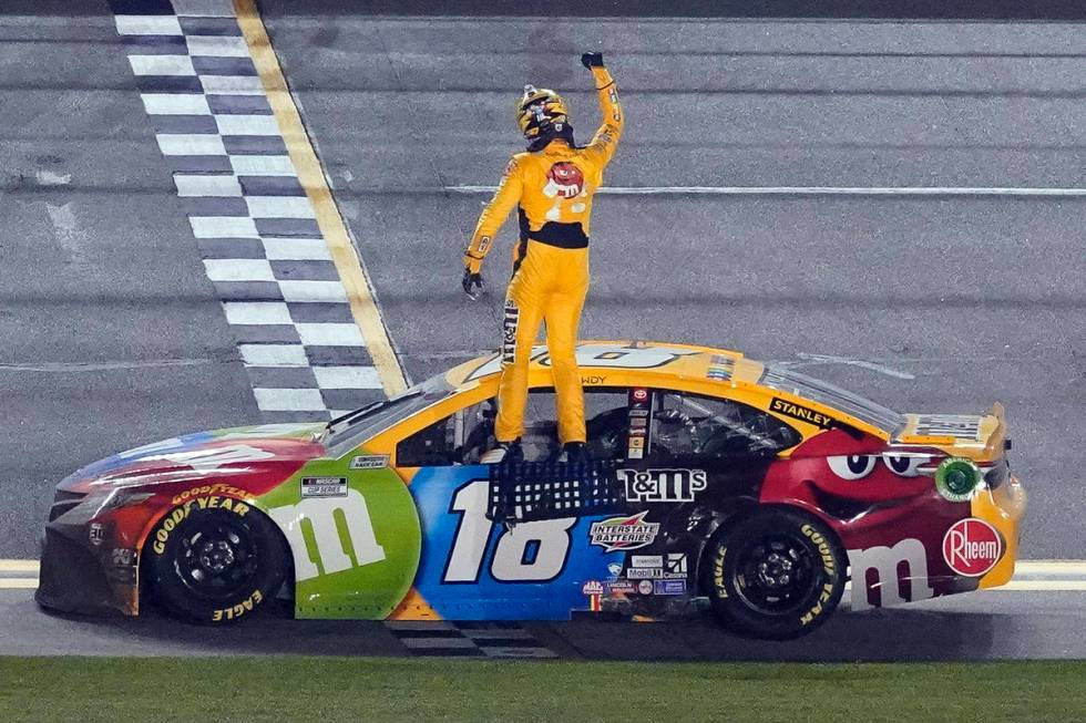 Kyle Busch celebrates on the top of his car after winning the NASCAR Clash auto race at Daytona ...