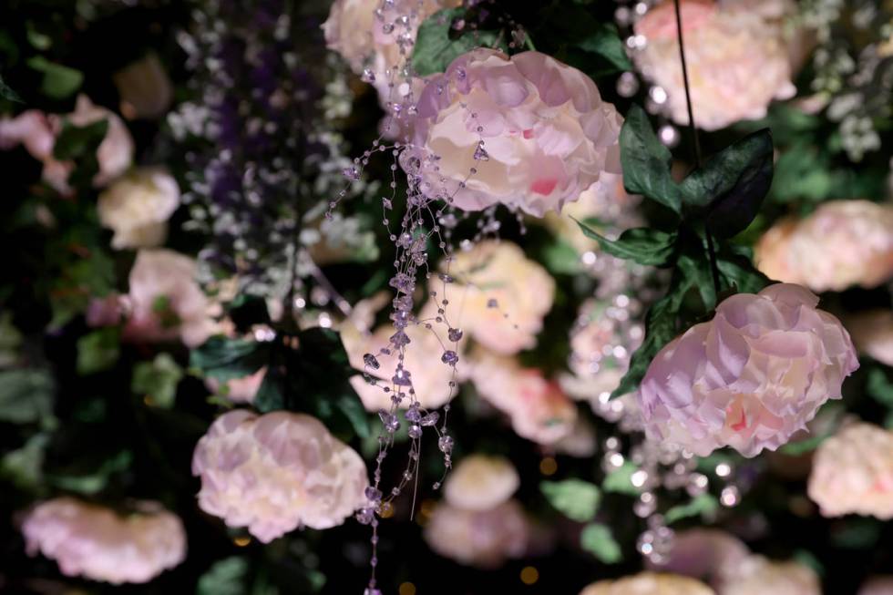 Flowers hang from the rounded ceiling in the entryway for seasonal pop-up bar, Crimson in Bloom ...