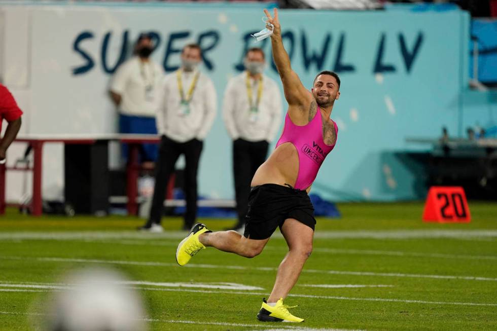 A fan runs on the field during the second half of the NFL Super Bowl 55 football game between t ...