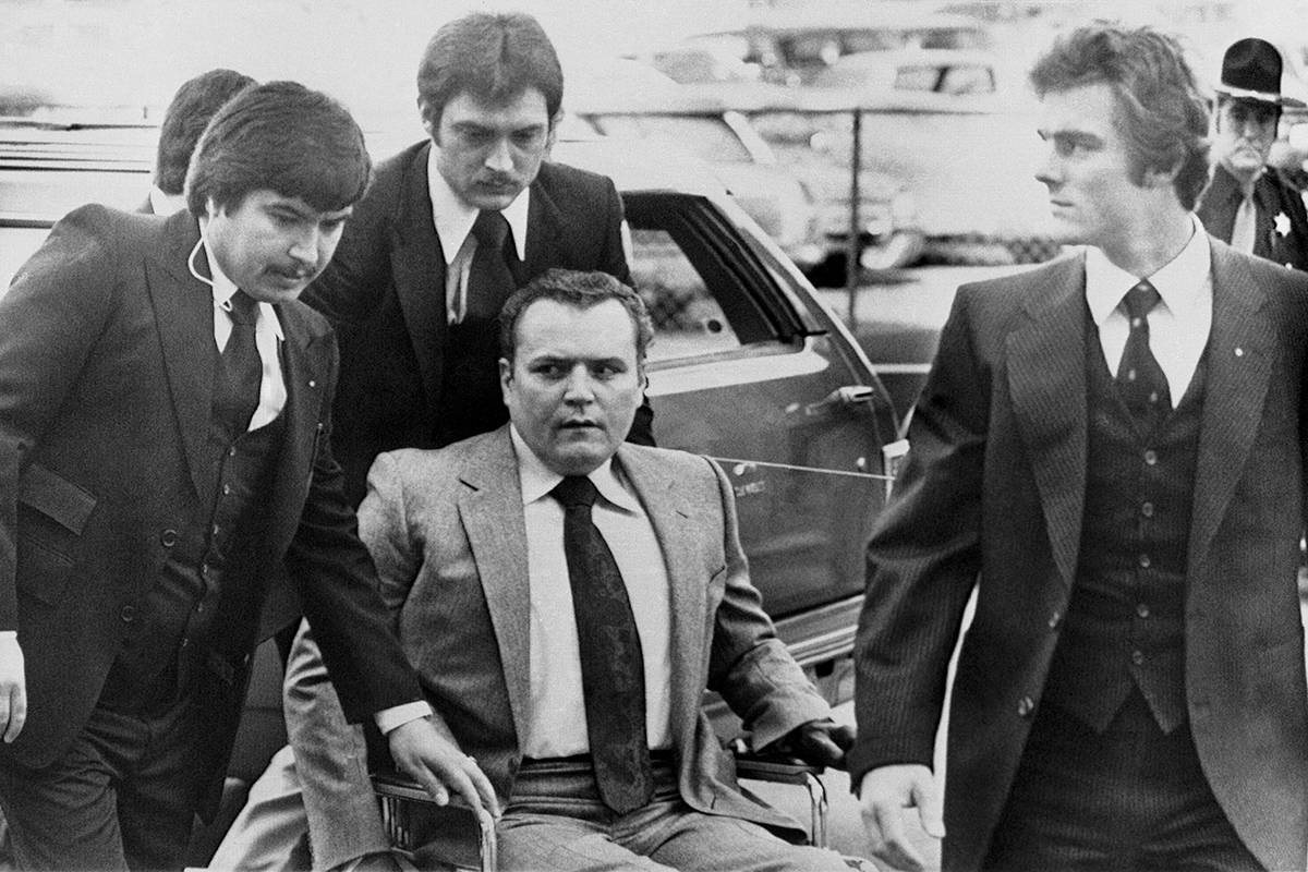 Hustler magazine publisher Larry Flynt is surrounded by heavy security as he arrives at the Ful ...