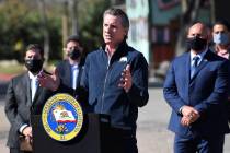 California Gov. Gavin Newsom, center, gestures in front of local officials while speaking about ...