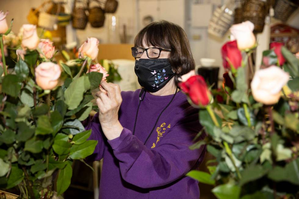 Susan DiBella, co-owner of DiBella Flowers & Gifts, assembles flower bouquets in preparatio ...