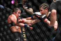 Maycee Barber, left, gets knocked to the cage by Roxanne Modafferi during their flyweight bout ...