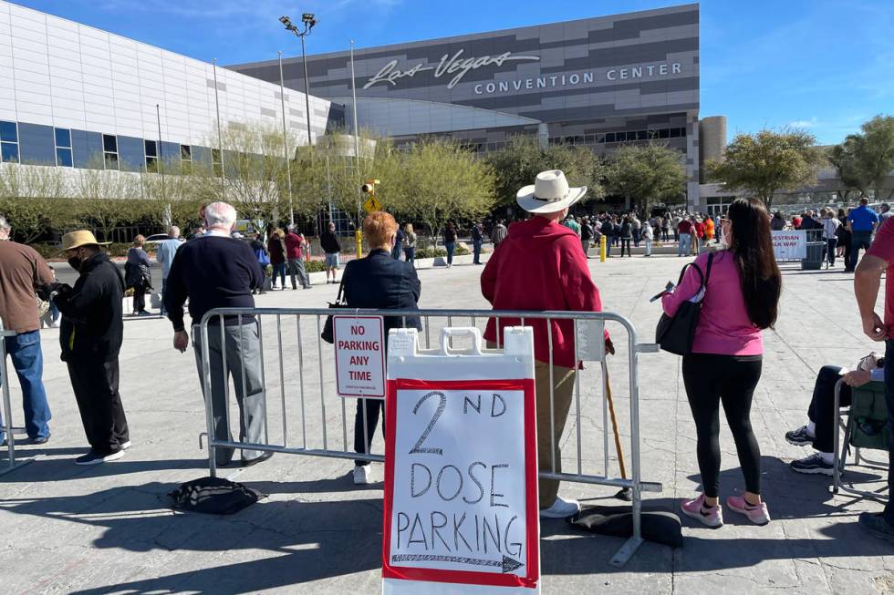 People line up for the second dose of the COVID-19 vaccine outside the Las Vegas Convention Cen ...