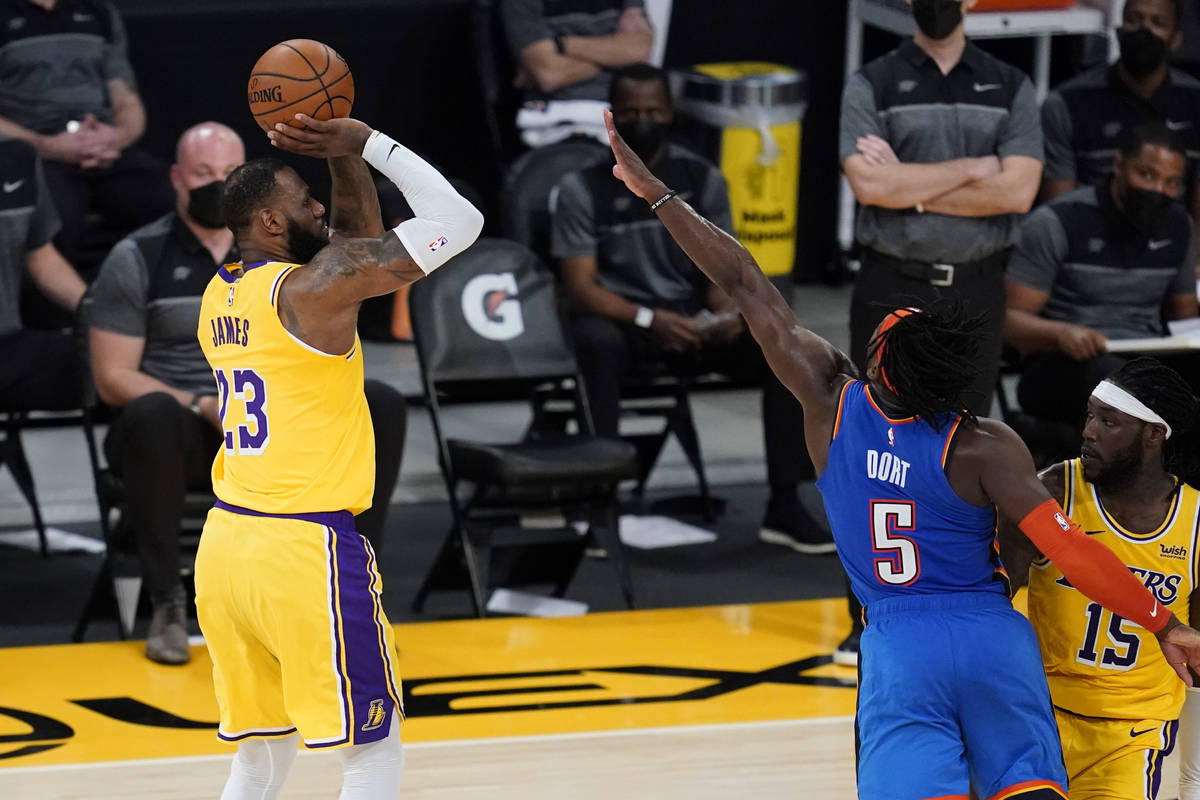 Los Angeles Lakers forward LeBron James (23) makes a 3-pointer against the Oklahoma City Thunde ...