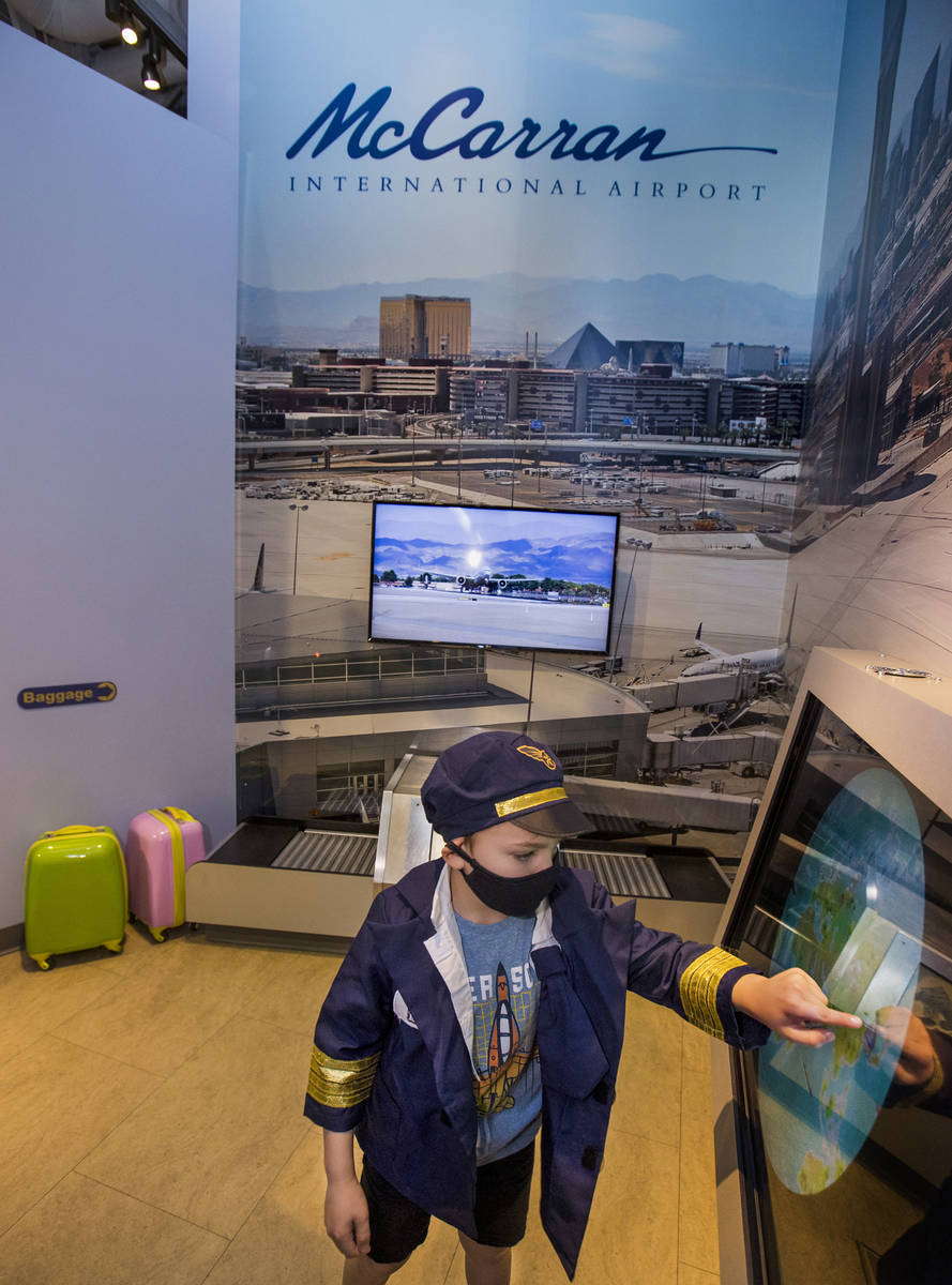 Clark Nicholson, 6, role-plays as an air traffic controller within the DISCOVERY Children's Mus ...