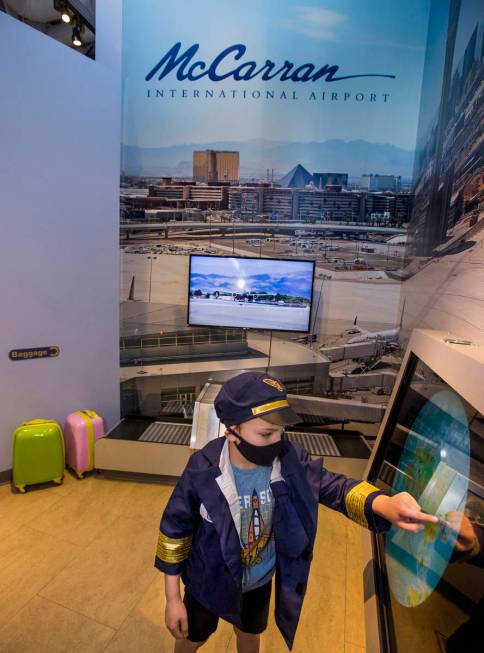 Clark Nicholson, 6, role-plays as an air traffic controller within the DISCOVERY Children's Mus ...