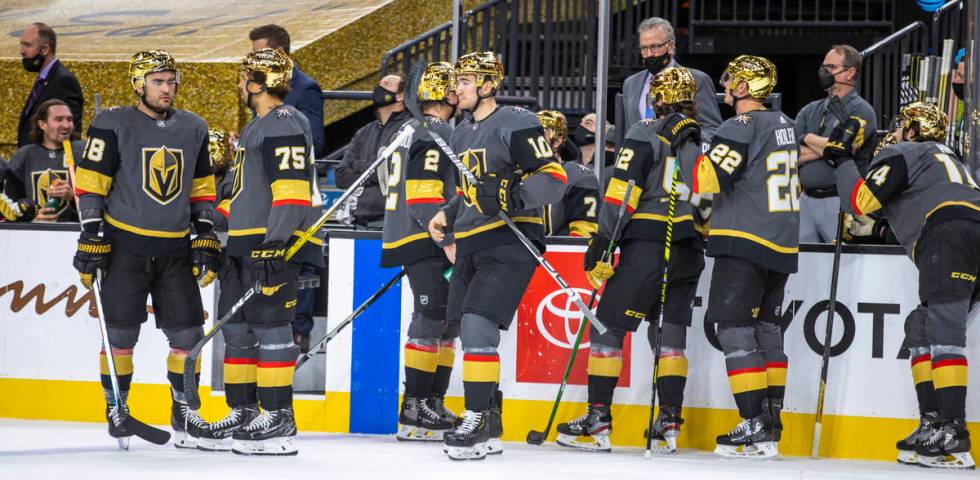 Golden Knights players and their new helmets versus the Anaheim Ducks during a timeout in the f ...