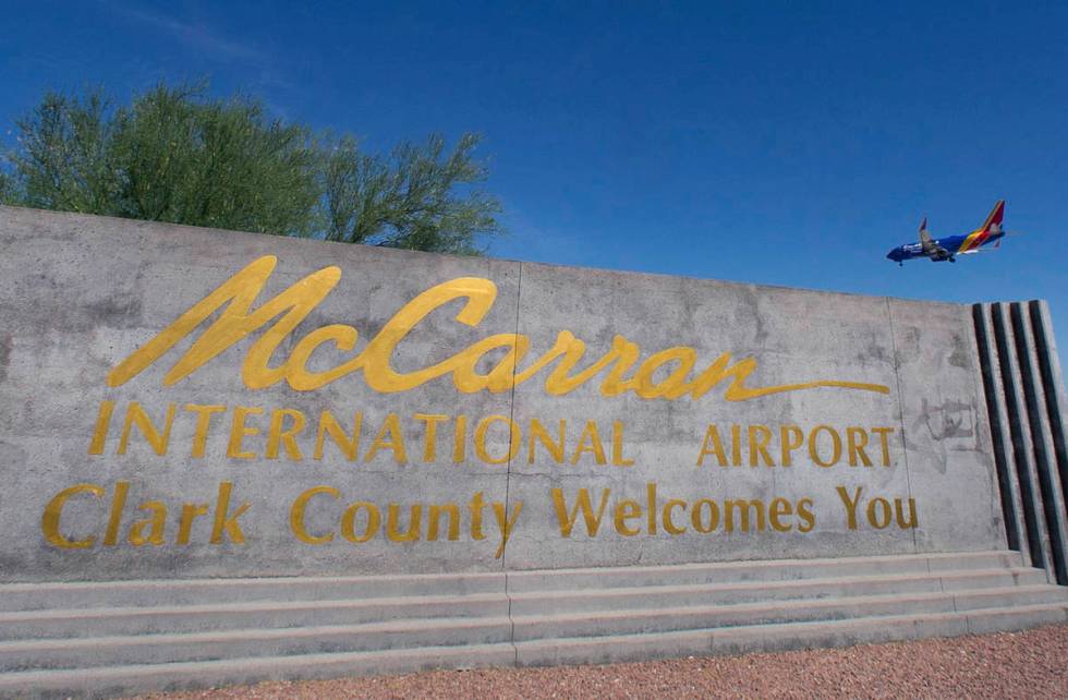 McCarran International Airport sign is seen as a Southwest Airways plane prepares to land in th ...