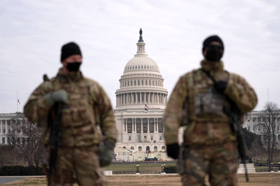 Members of the national guard patrol the area outside of the U.S. Capitol during the impeachmen ...