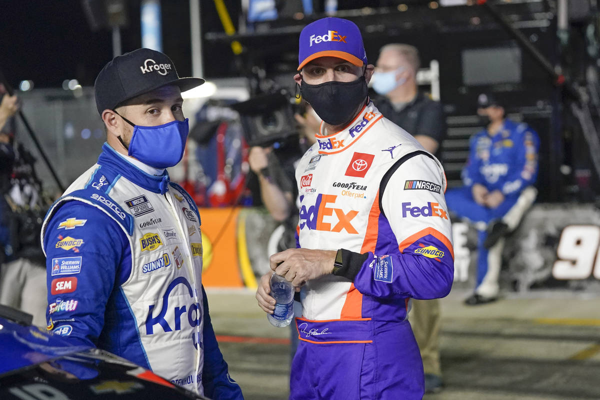 Ricky Stenhouse Jr., left, and Denny Hamlin talks on pit road before the first of two qualifyin ...