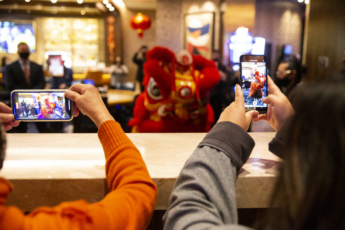 People watch The Lohan School of Shaolin perform the Chinese Lion dance in celebration of the L ...
