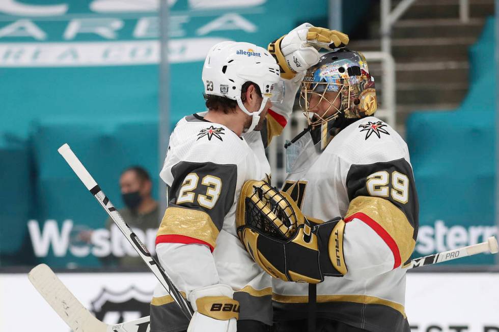 Vegas Golden Knights defenseman Alec Martinez (23) celebrates with Vegas Golden Knights goalten ...