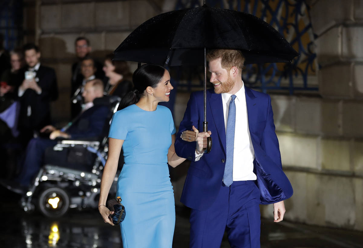 FILE - Britain's Prince Harry and Meghan arrive at the annual Endeavour Fund Awards in London, ...