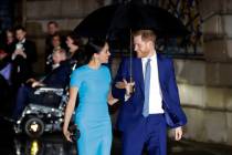 FILE - Britain's Prince Harry and Meghan arrive at the annual Endeavour Fund Awards in London, ...