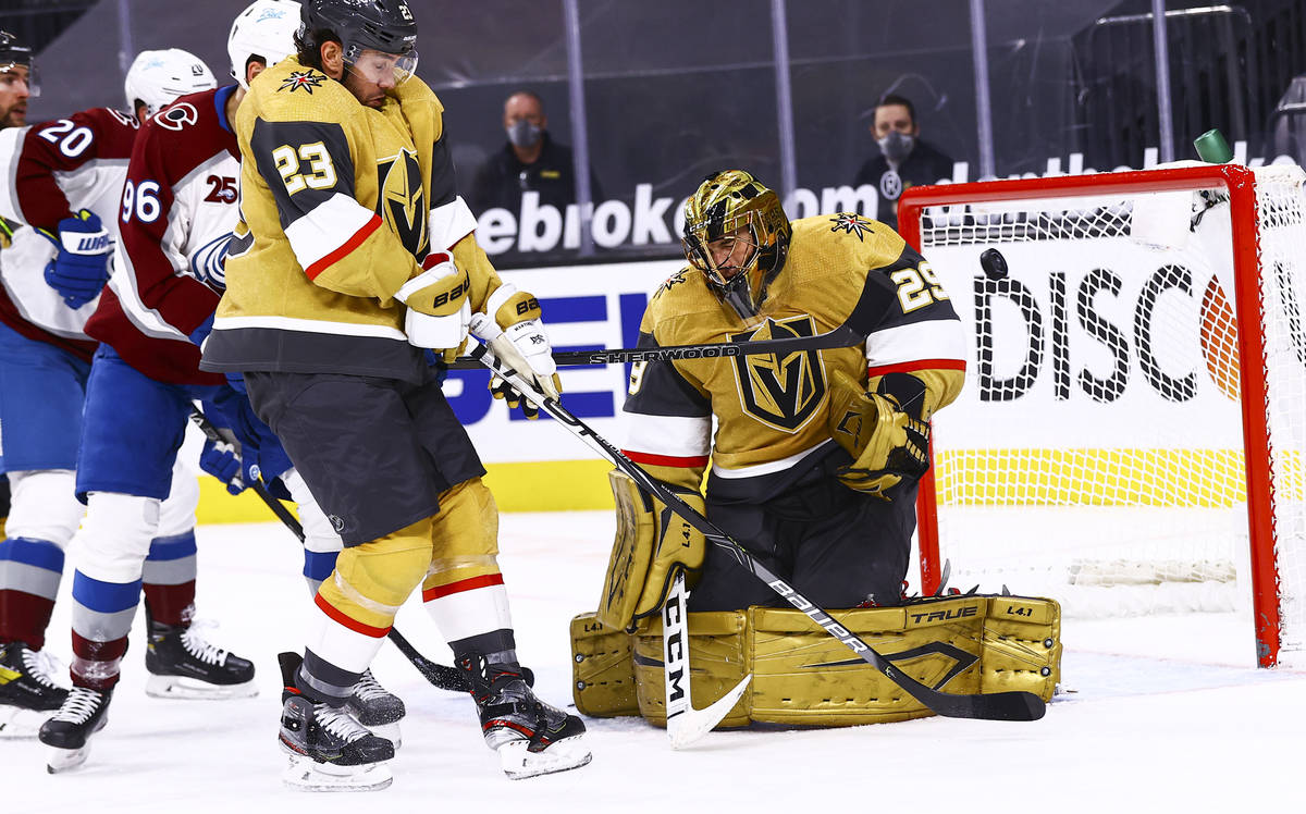 Golden Knights goaltender Marc-Andre Fleury (29) blocks the puck in front of Golden Knights def ...