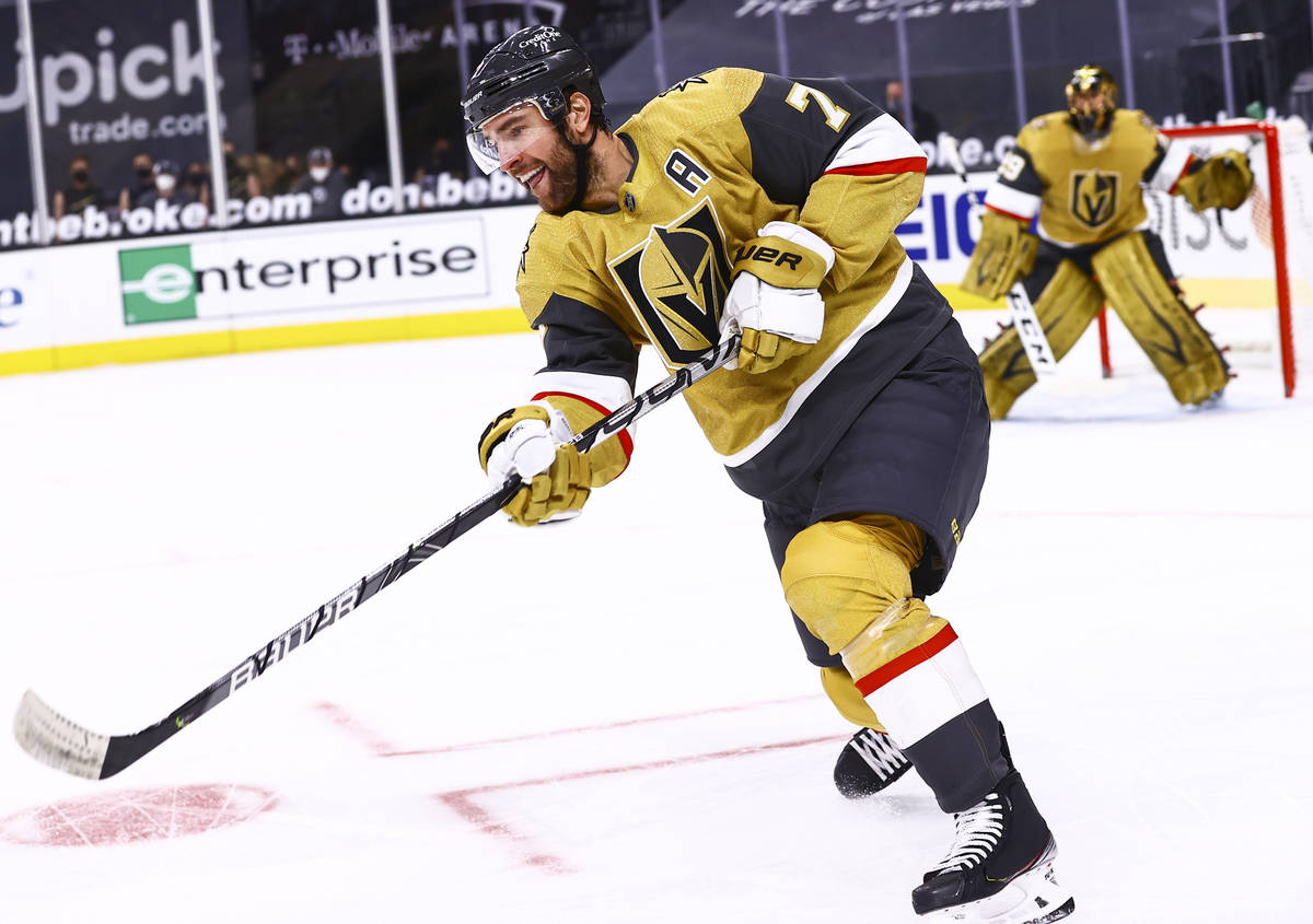 Golden Knights center Nicolas Roy (10) sends the puck up the ice during the first period of an ...