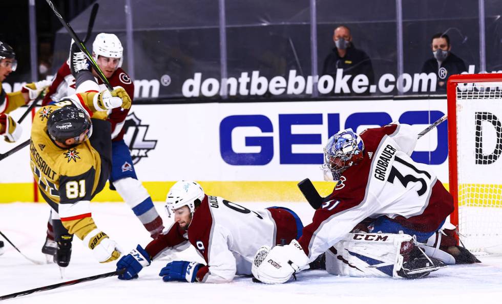 Colorado Avalanche goaltender Philipp Grubauer (31) stops the puck as Golden Knights center Jon ...