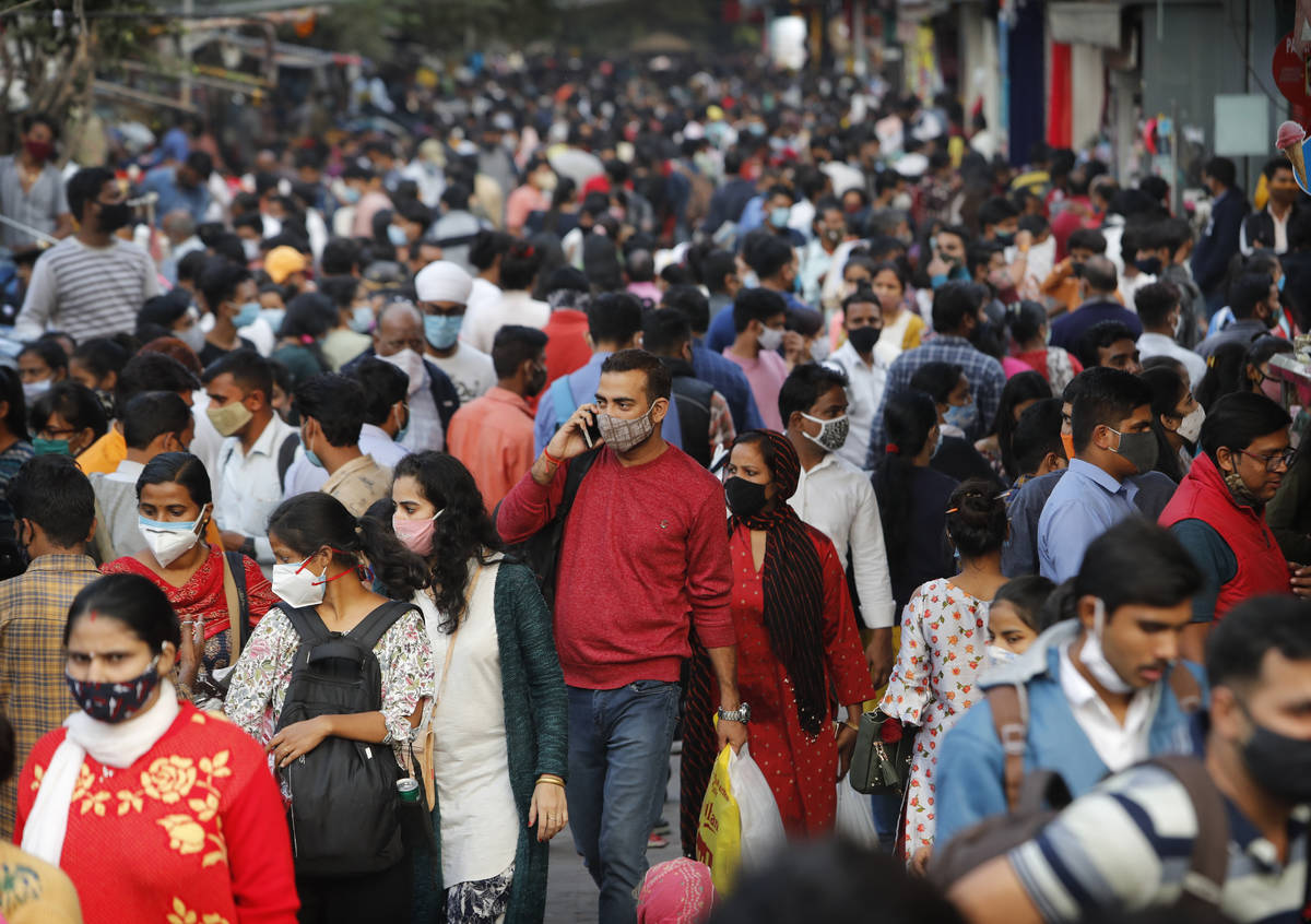 FILE - In this Nov. 12, 2020, file photo, people walk in a market to shop ahead of the Diwalli ...