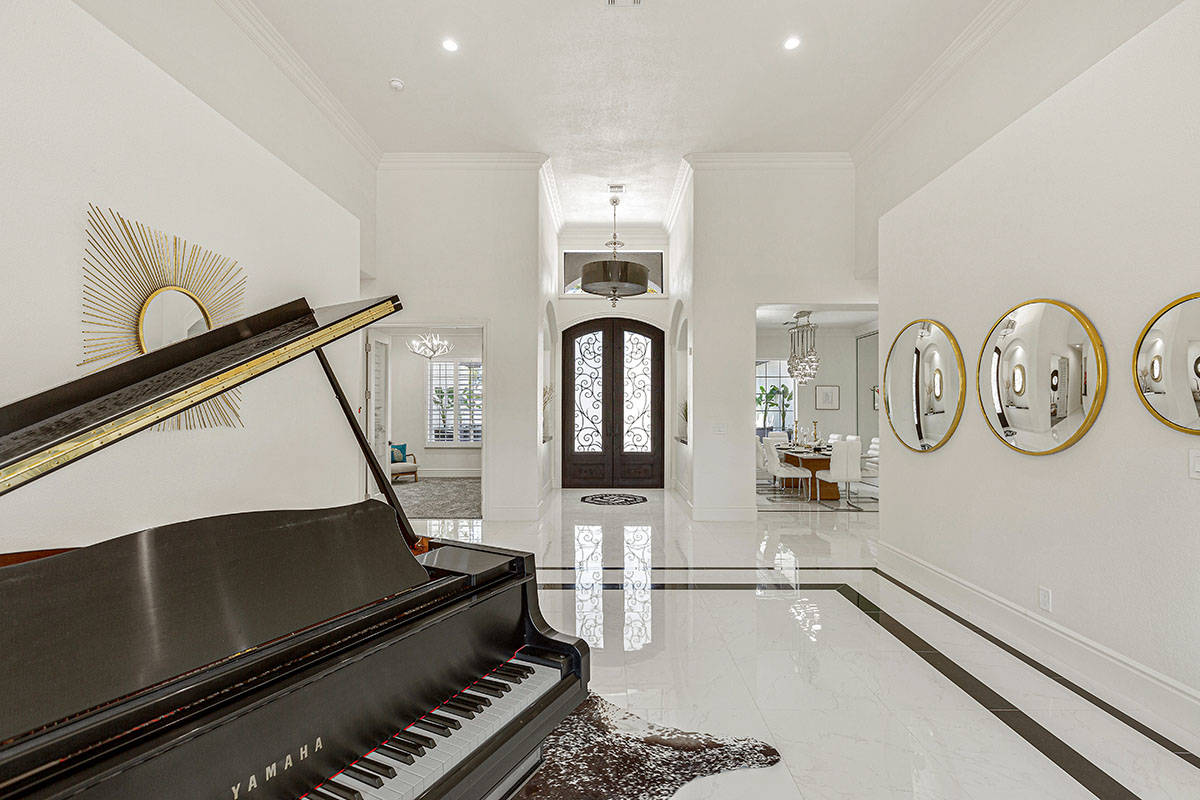 The renovated 8,010-square-foot home at 6645 W. El Campo Grande Ave. features a piano in the li ...