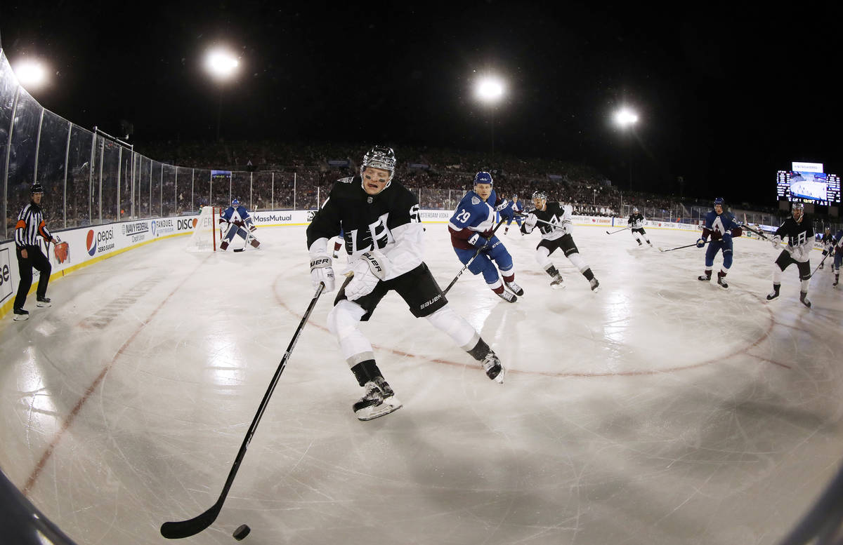 Los Angeles Kings left wing Austin Wagner, front, picks up the puck as Colorado Avalanche cente ...