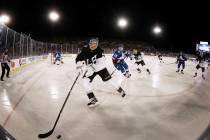 Los Angeles Kings left wing Austin Wagner, front, picks up the puck as Colorado Avalanche cente ...