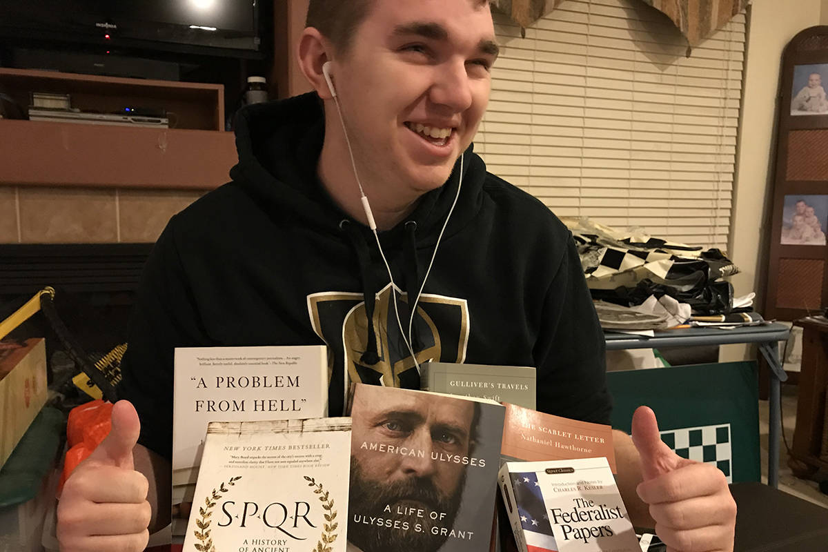 Brayden Smith, an avid reader, is pictured with some of his many books. (Scott and Debbie Smith)