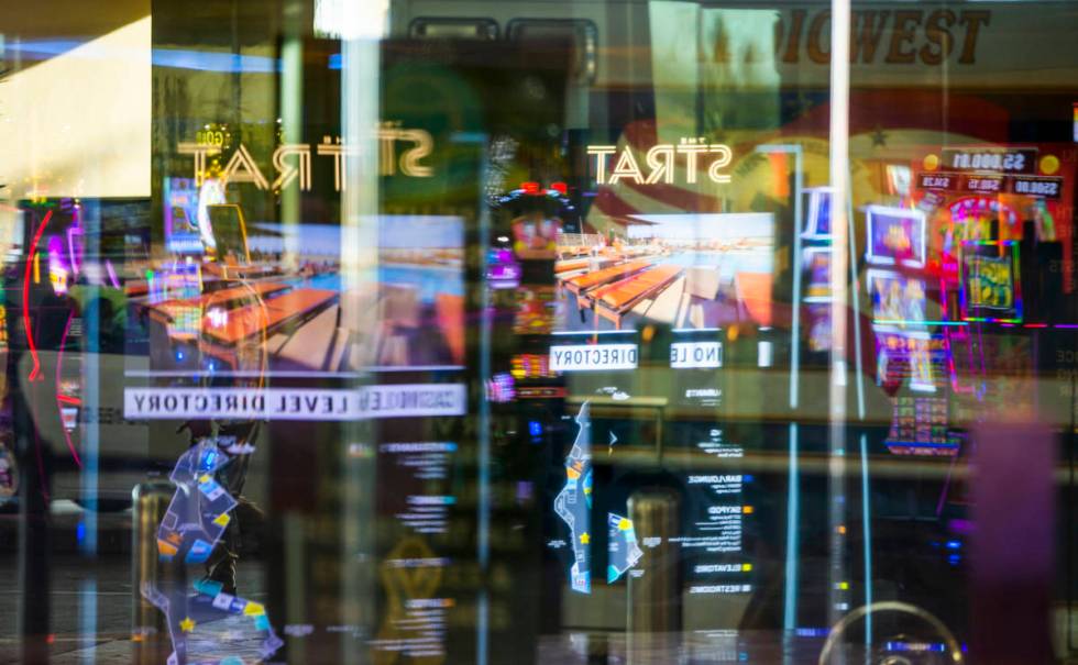 A variety of reflections about the main door at The Strat as casino floors have moved up to 35% ...