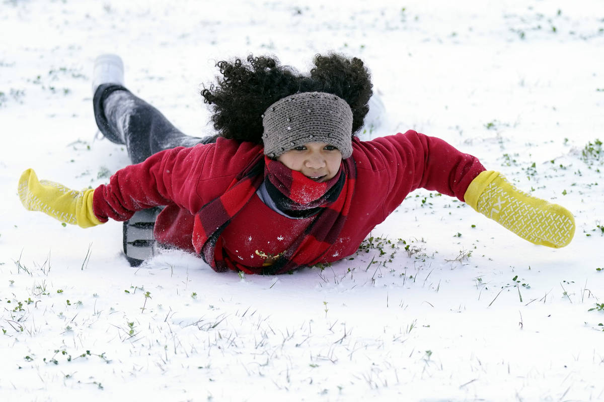 Alyssa Remi, 12, slides down a snow covered hill Monday, Feb. 15, 2021, in Houston.A winter sto ...