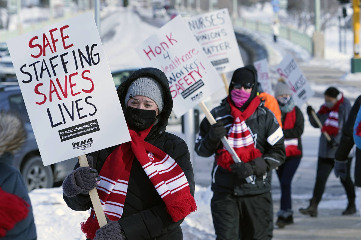 Nurses picket Friday, Feb. 12, 2021 in Faribault, Minn., during a healthcare worker protest of ...