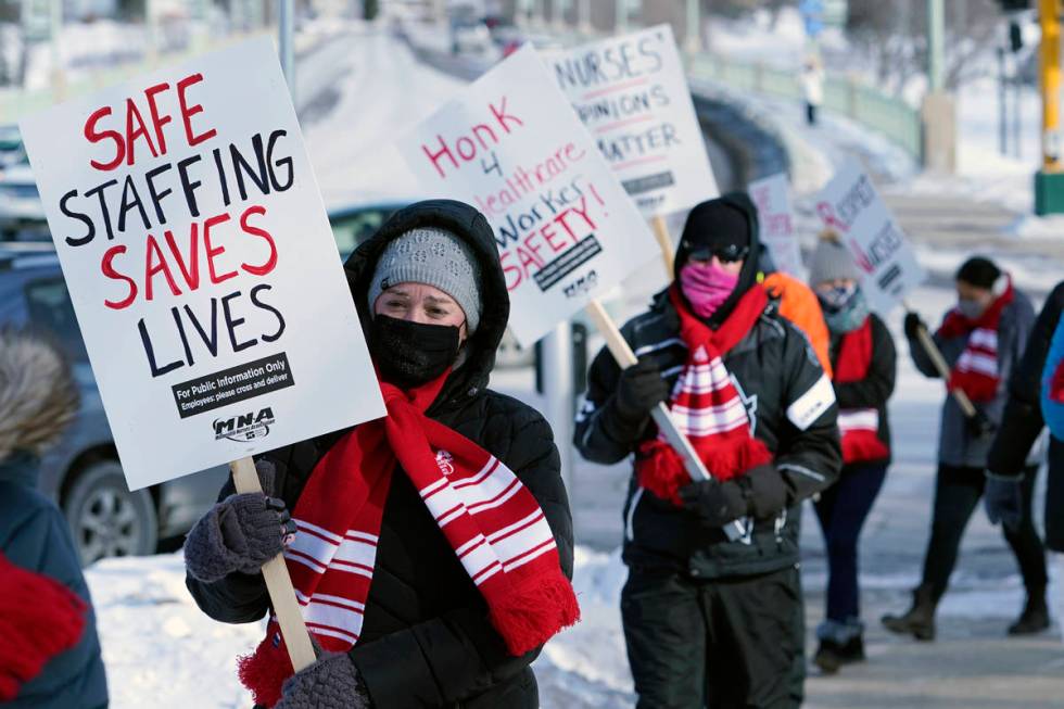 Nurses picket Friday, Feb. 12, 2021 in Faribault, Minn., during a healthcare worker protest of ...