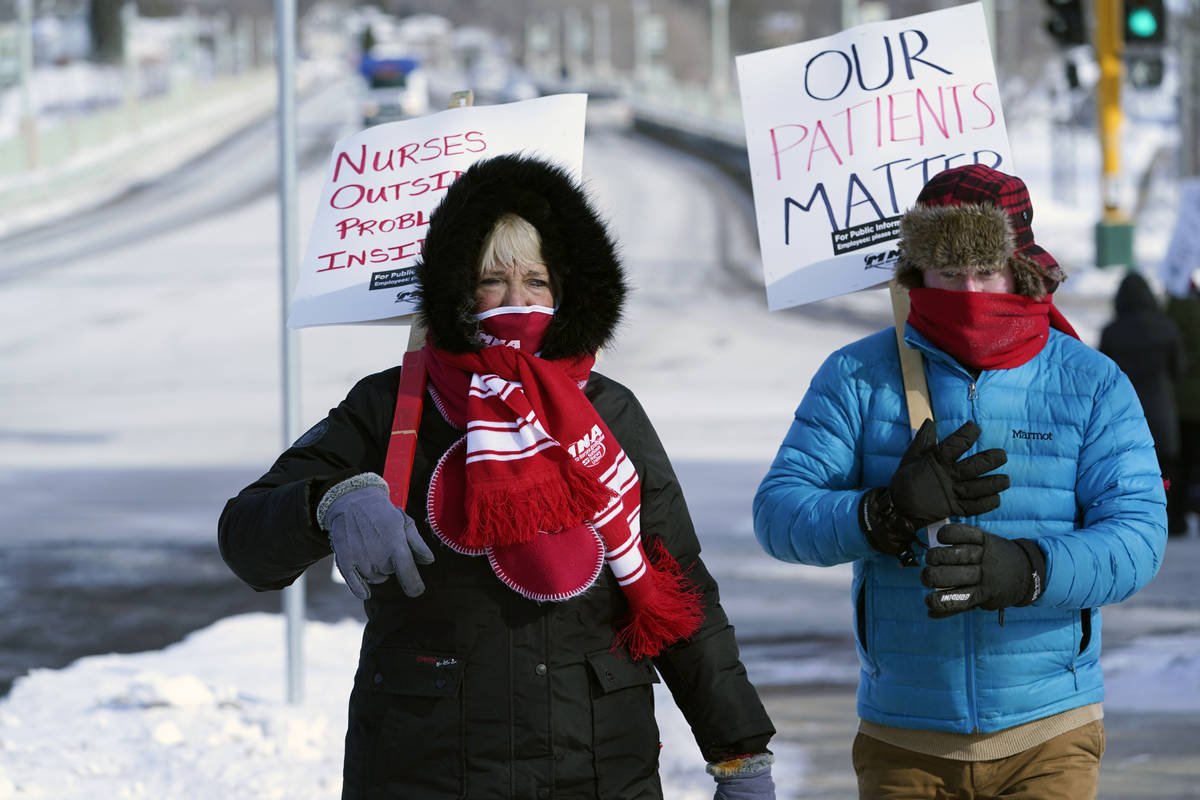 Nurses, including Mary Turner, left, picket Friday, Feb. 12, 2021 in Faribault, Minn.,as part o ...