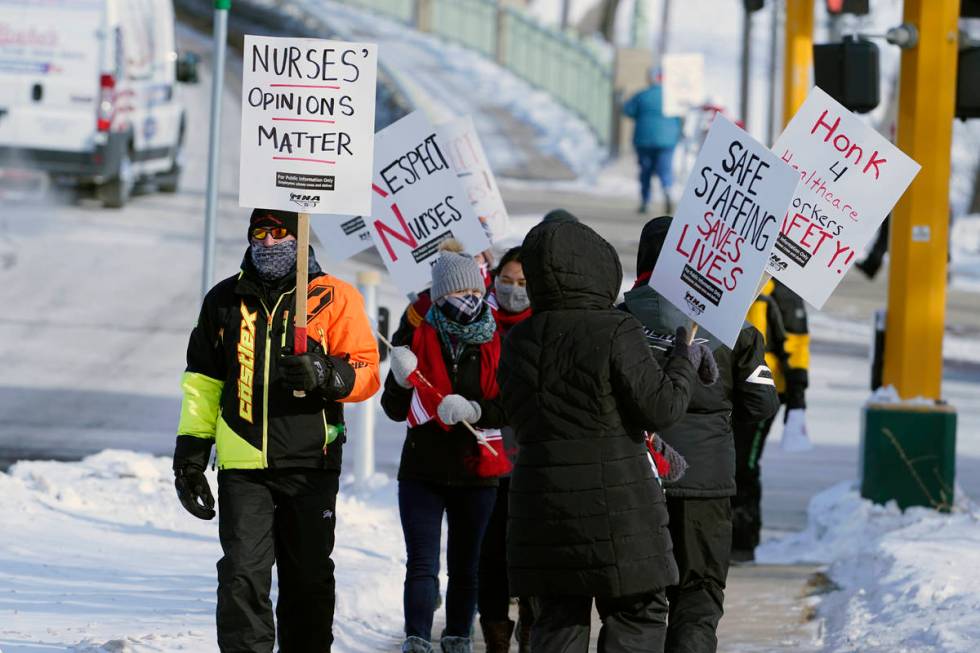 Nurses picket Friday, Feb. 12, 2021 in Faribault, Minn., during a healthcare worker protest of ...