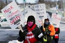 Nurses picket Friday, Feb. 12, 2021 in Faribault, Minn., during a healthcare worker protest of ...