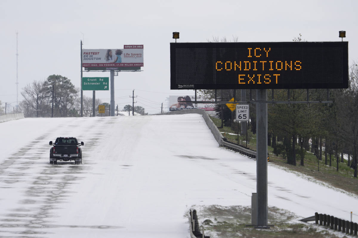A truck drives past a highway sign Monday, Feb. 15, 2021, in Houston. A frigid blast of winter ...