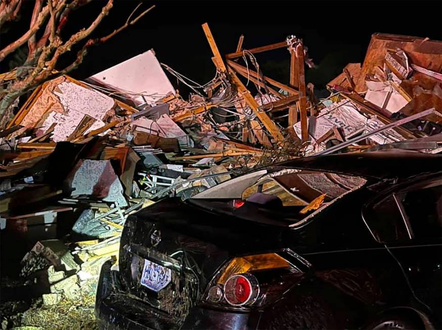 A damaged vehicle sits among debris after a deadly tornado tore through Brunswick County, N.C., ...