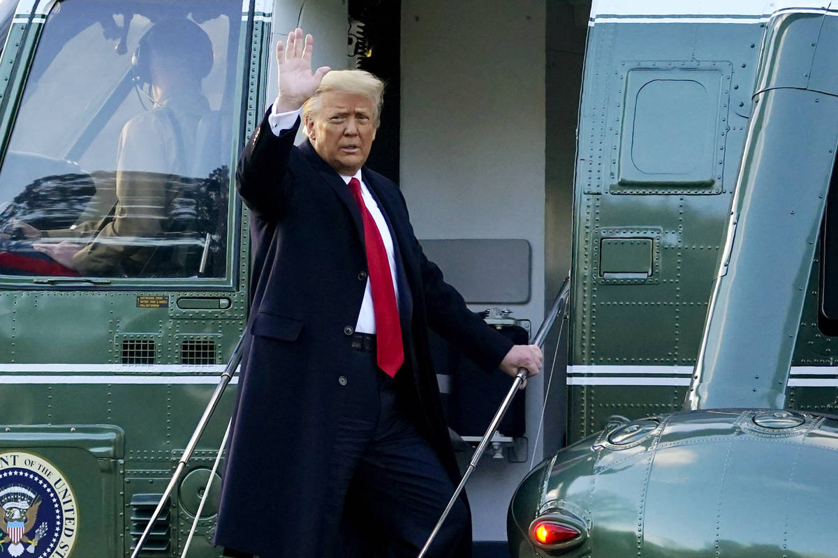 In this Wednesday, Jan. 20, 2021, file photo, President Donald Trump waves as he boards Marine ...