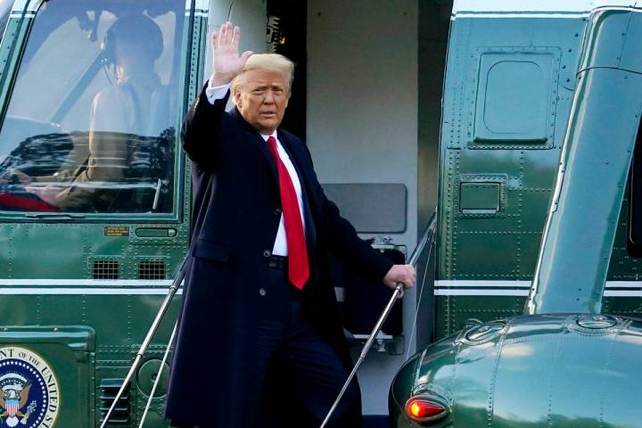 In this Wednesday, Jan. 20, 2021, file photo, President Donald Trump waves as he boards Marine ...