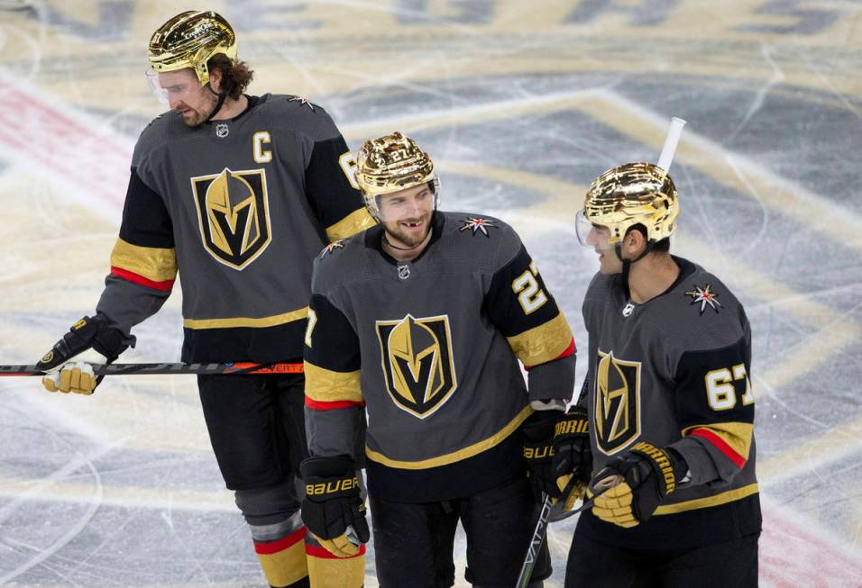 Golden Knights defenseman Shea Theodore (27) communicates with left wing Max Pacioretty (67) al ...