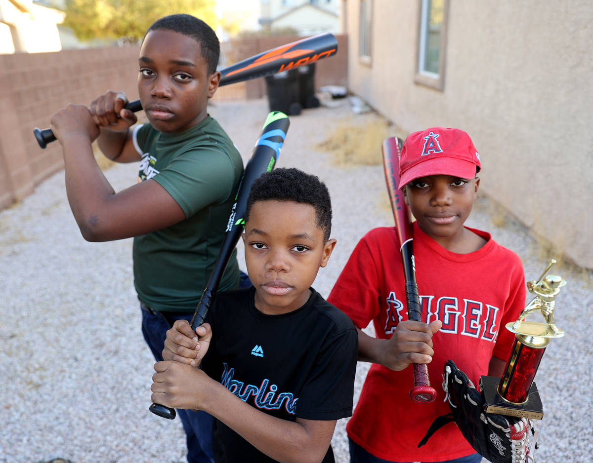 Brothers, from left, Marcel Aron Elzy, 13, Marlon Ray Elzy, 8, and Markez Lee Elzy, 9, at their ...