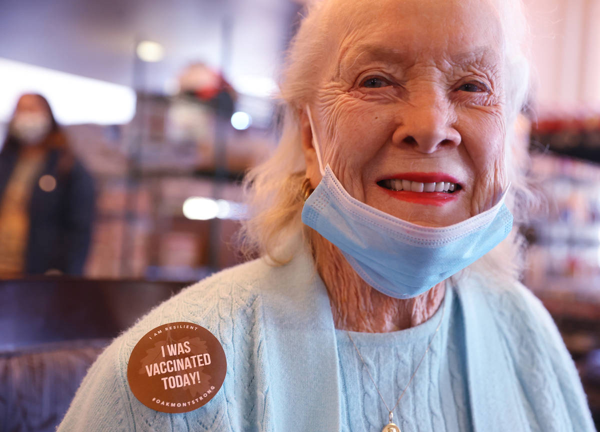 Jeanne Costa, 91, shows her "I was vaccinated today!" sticker after receiving the Pfi ...