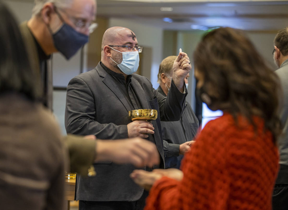 Pastor Bob Sundquist, center, and Pastor Craig Michaelson lead communion during an Ash Wednesda ...