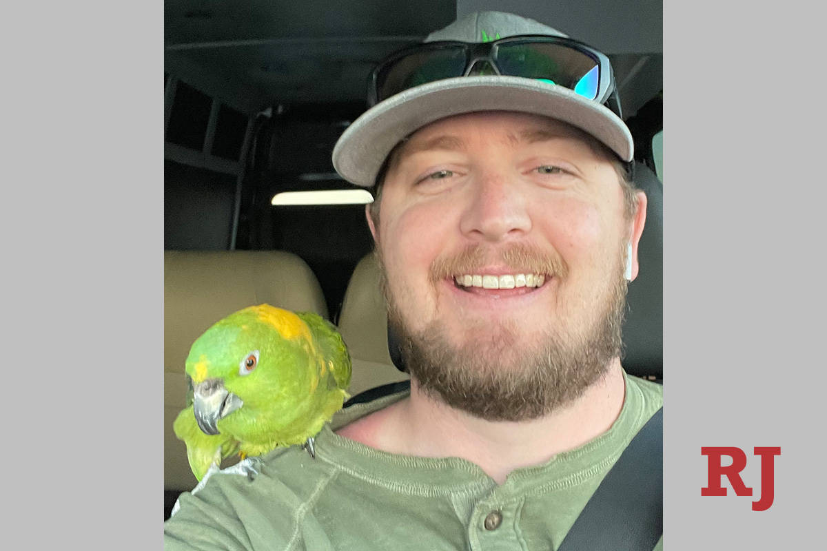Dylan Hazelhurst, 30, poses with Fred, his 45-year-old rescued yellow-breasted Amazon parrot. A ...