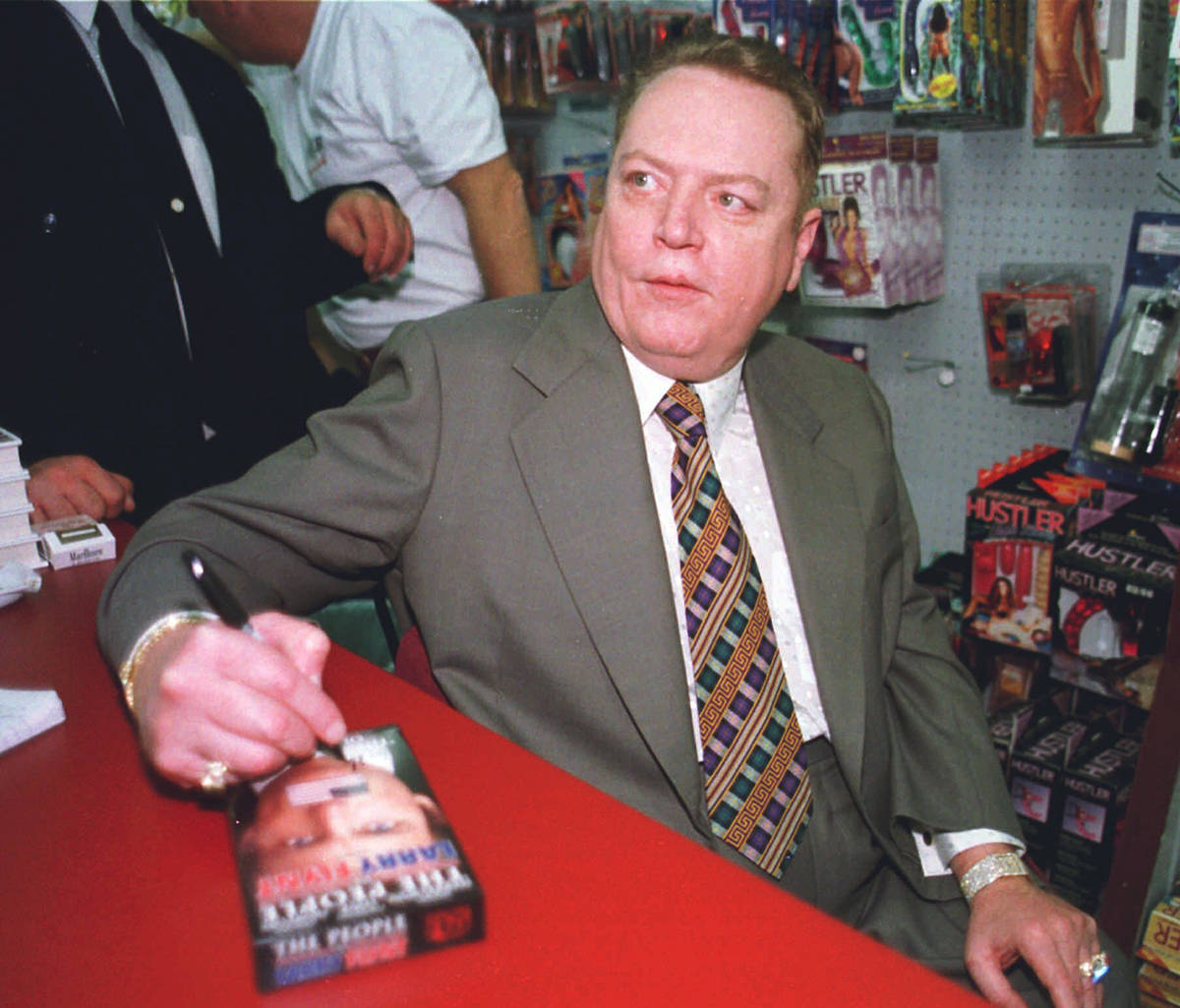 In this file photo, "Hustler" magazine editor Larry Flynt signs a copy of "The People Vs. Larry ...