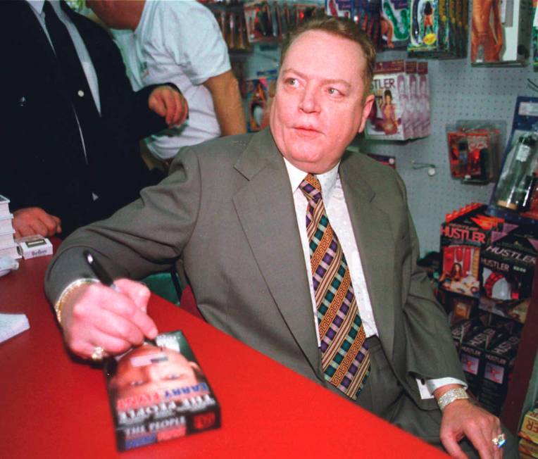 In this file photo, "Hustler" magazine editor Larry Flynt signs a copy of "The People Vs. Larry ...
